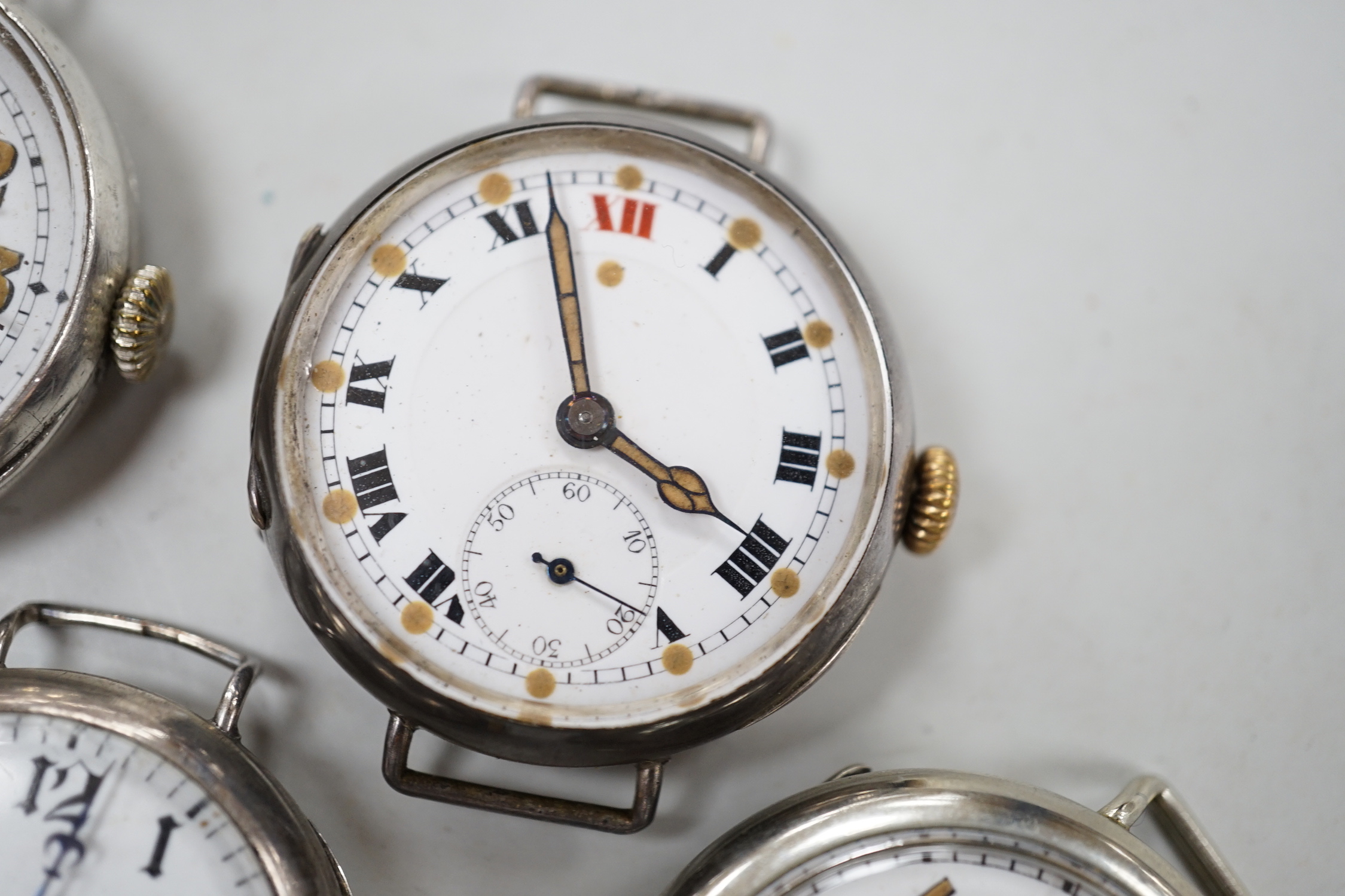 Five assorted early to mid 20th century manual wind wrist watches, including four silver.